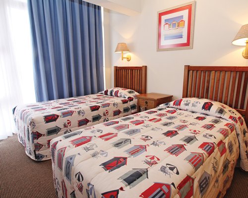 A well furnished bedroom with two twin beds.