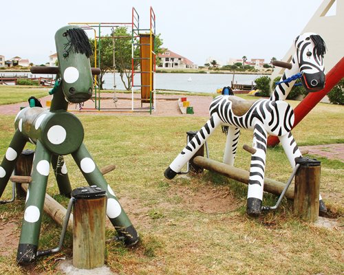 A scenic outdoor children's play area alongside the waterfront.