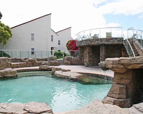 An outdoor pool alongside resort units.