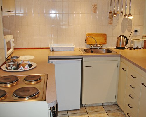 A well equipped kitchen with a microwave oven.