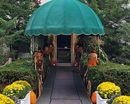 A covered entrance with flowers and decorations at dusk.