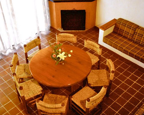 A well furnished dining room with a fireplace.