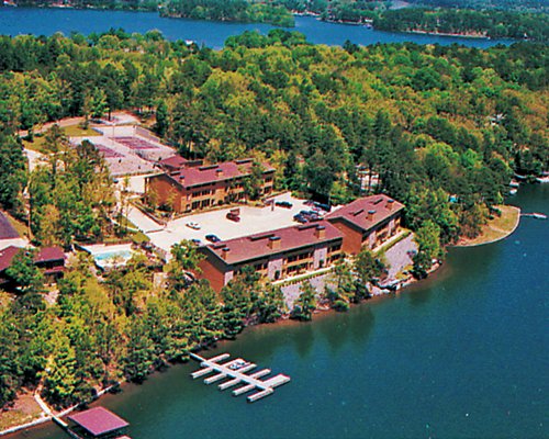 Exterior view of The Wharf surrounded by wooded area alongside the lake.