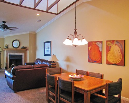 A well furnished living room with dining area and fireplace.