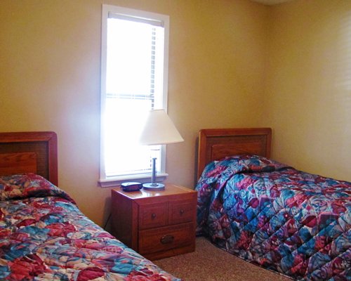 A well furnished bedroom with two beds and an outside view.