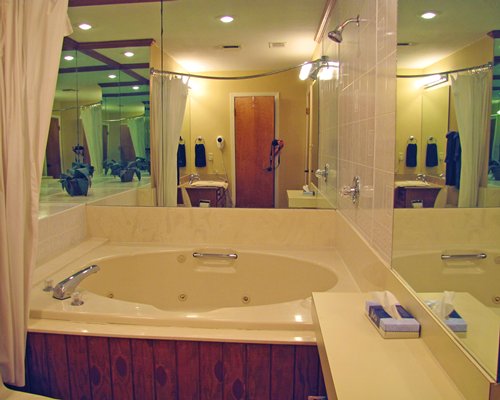 A bathroom with shower and bathtub.