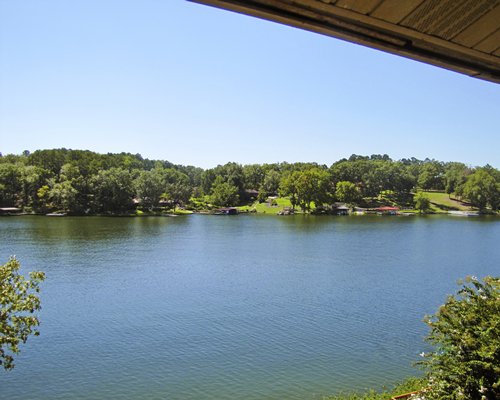 View of the lake surrounded by wooded area.