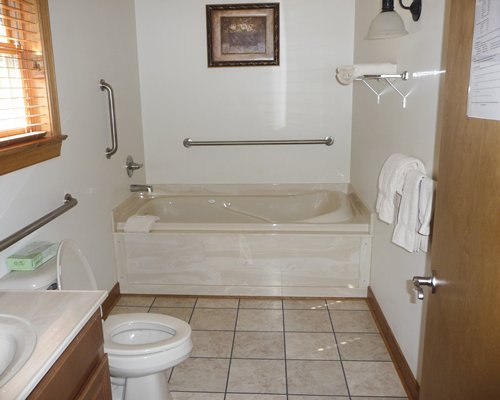 Bathtub and shower with closed vanity sink.