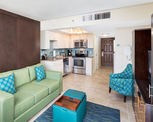 A well furnished living room with open plan kitchen.