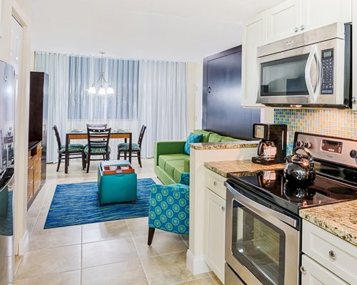 A well furnished living room with dining area and open plan kitchen.