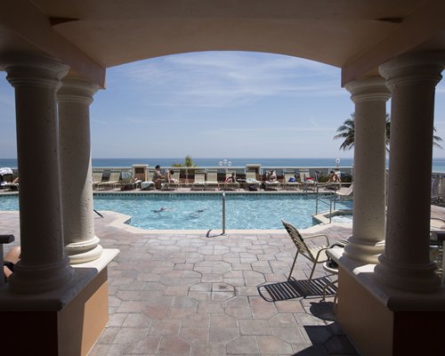 An outdoor swimming pool with chaise lounge chairs.