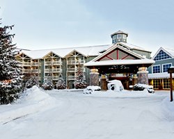 An exterior view of the Birchcliff Villas At Deerhurst Resort covered in snow.