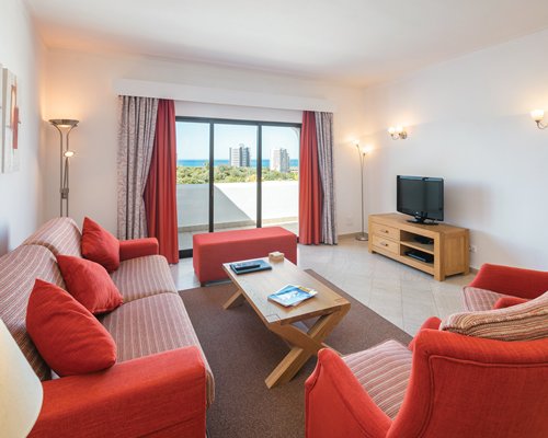 A well furnished living area with a television and an outside view.