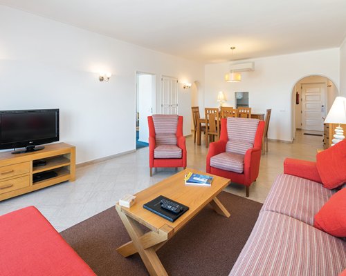 An open plan living room and dining area with a television.