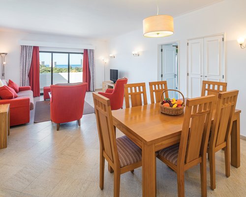 An open plan living dining with a television and an outside view.