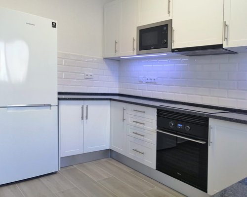 A well equipped kitchen with an outside view.