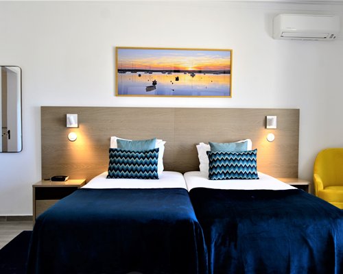A well furnished bedroom and a balcony with patio.