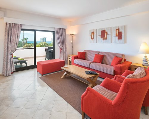 A well furnished living room with a double pull out sofa television and patio.