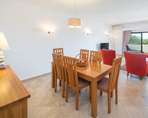 An open plan living dining with a television and an outside view.