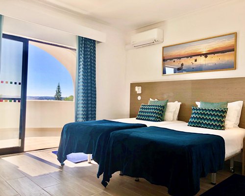 A well furnished bedroom with an outside view.