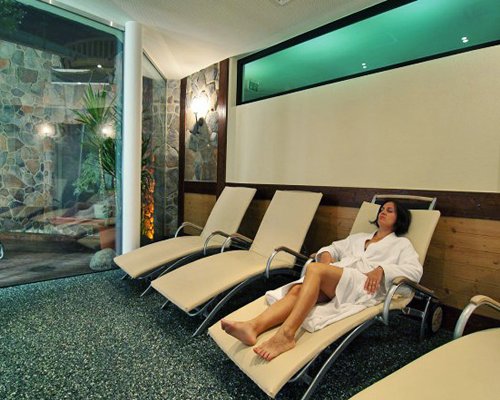 View of girl relaxing in a chaise lounge chairs.