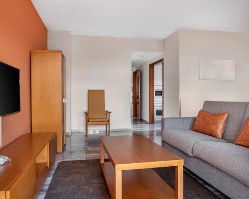A well furnished bedroom with a queen bed and an outside view.
