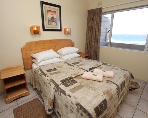 A well furnished bedroom with an outside view.