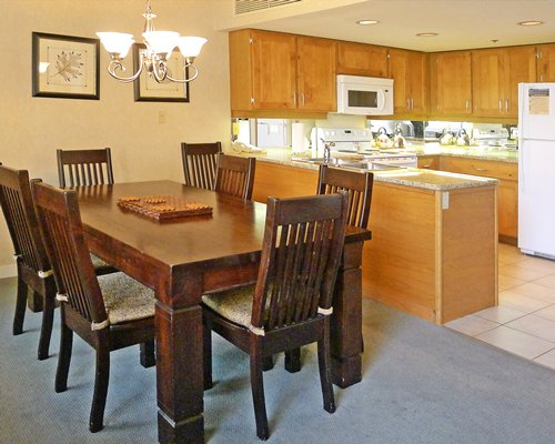A well furnished dining area alongside the kitchen.