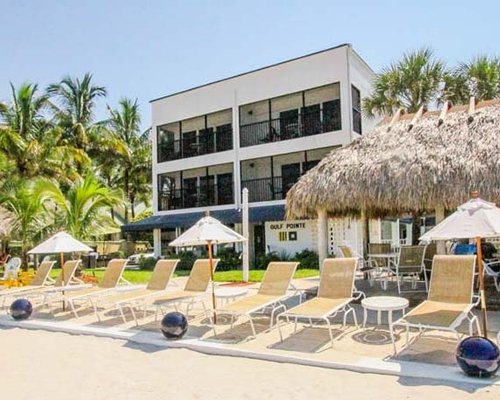 A view of chaise lounge chairs and sunshades alongside the resort.