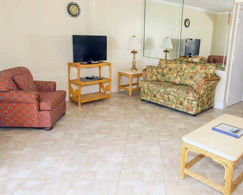 Living room with television alongside a common room.