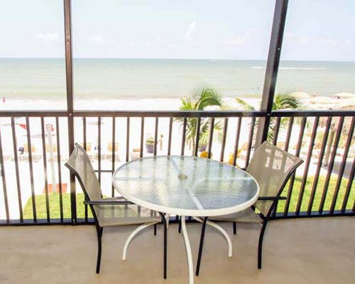 A balcony with patio furniture overlooking the Gulf of Mexico.