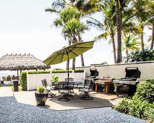 An outdoor dining area with barbecue grills.