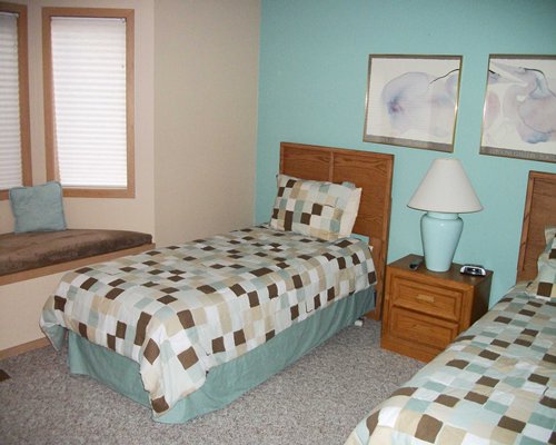 A well furnished bedroom with two twin beds.