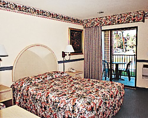 A well furnished bedroom with a patio.