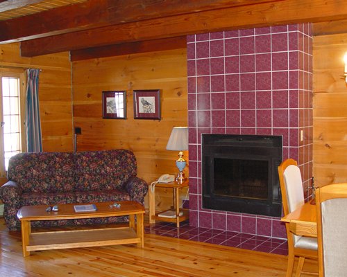 A well furnished living room with a dining area and fireplace.