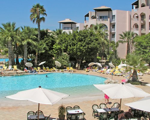A large outdoor swimming pool  alongside the resort.