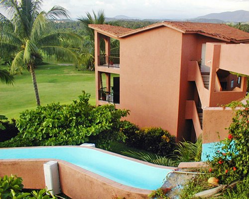 An exterior view of resort units alongside a water slide.