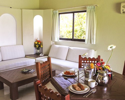 An open plan living room with a wooden dining area.