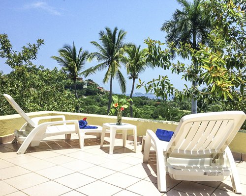 View of chaise lounge chairs in the balcony.