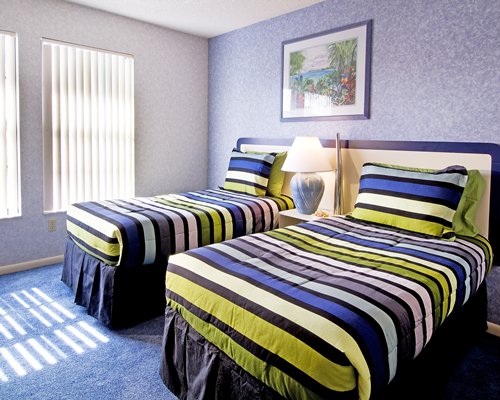 A well furnished bedroom with two twin beds.
