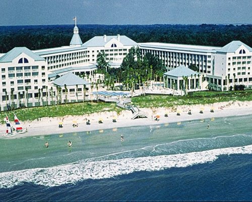 Scenic exterior view of Ocean Palms Resort alongside the beach.