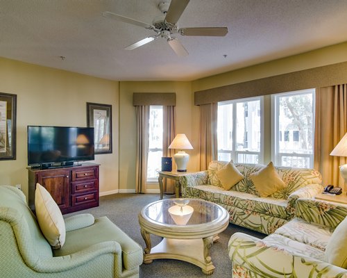A well furnished living area with pull out sofa alongside dining with an outside view.