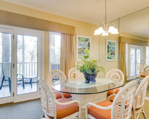 A well furnished living room with an open plan kitchen and dining area.