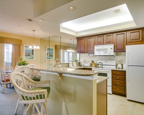 Living room with open plan kitchen dining area and breakfast bar.