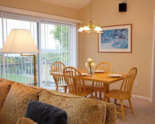 A well furnished living and dining area with an outside view.