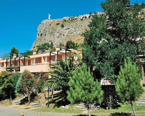 An exterior view of the resort units surrounded by trees.