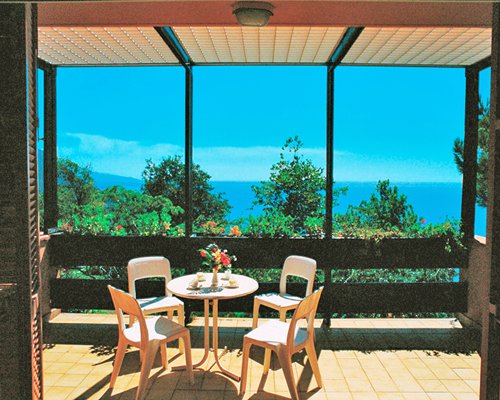 Balcony with patio furniture and ocean view.