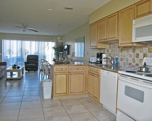 An open plan kitchen dining and living room with an outside view.