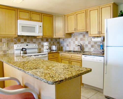 A well equipped kitchen with breakfast bar.