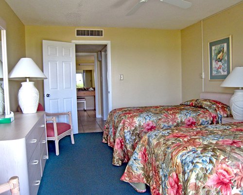 A well furnished bedroom with two beds.
